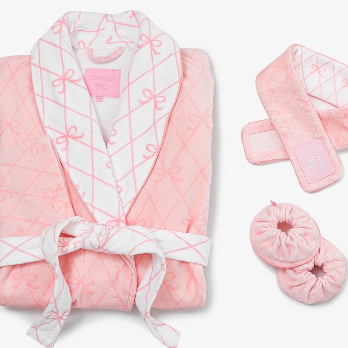 JUSTKASS pink bow beauty flatlay